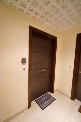 a door in a room with a mat in front of it at Apartment Montaigne in Cannes