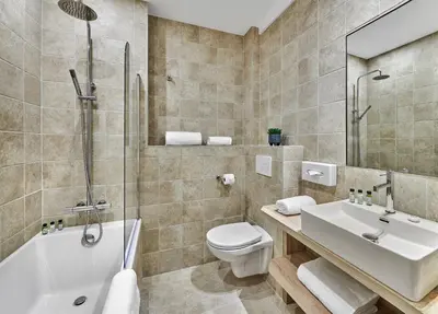 a bathroom with a toilet and a sink and a shower at Hotel Le Suquet Cannes in Cannes