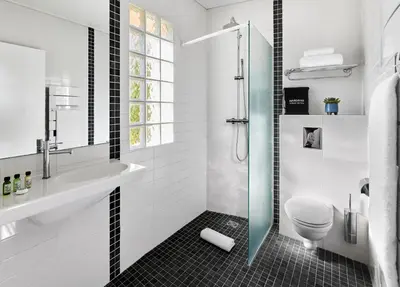 a bathroom with a shower and a sink and a toilet at Hotel Le Suquet Cannes in Cannes