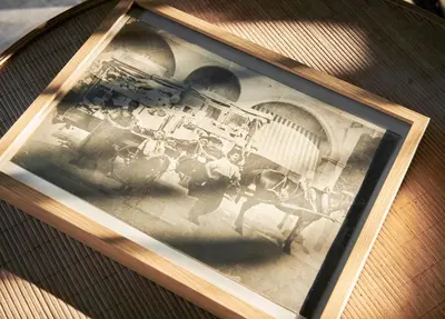 a picture in a wooden frame on a table at Hotel Le Suquet Cannes in Cannes