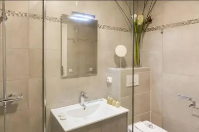 a bathroom with a sink and a vase of flowers at ESCURIAL Bel appart rénové proche Croisette et plage in Cannes