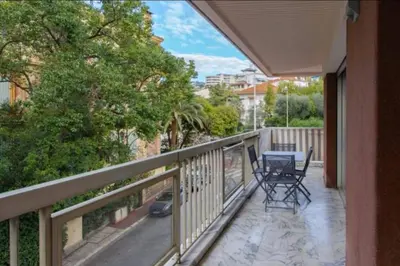 a balcony with two chairs and a table on it at ESCURIAL Bel appart rénové proche Croisette et plage in Cannes
