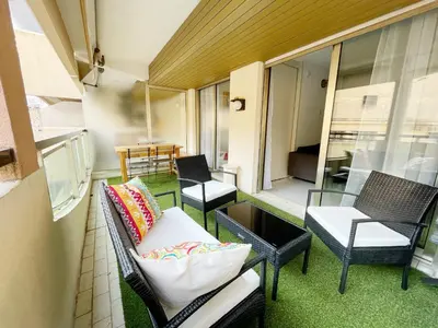 a balcony with two chairs and a couch on a building at T2 Cannes center in Cannes