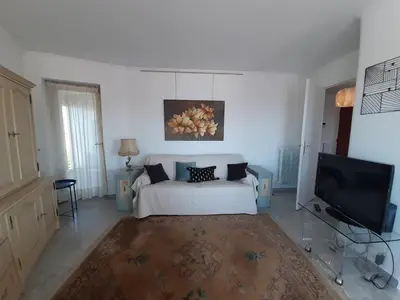 a living room with a bed and a tv at Le République in Cannes