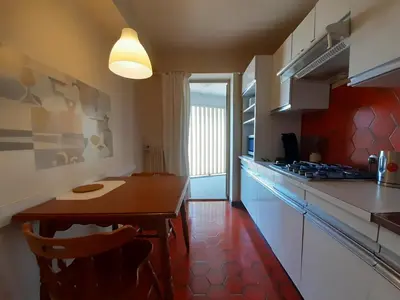 a kitchen with a wooden table in a room at Le République in Cannes