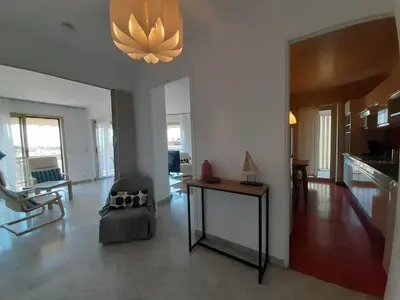 a large living room with a table and a couch at Le République in Cannes