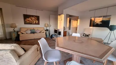 a living room with a table and a couch at Le République in Cannes