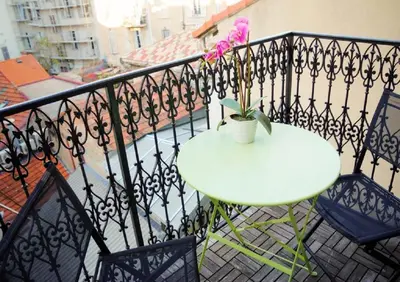 a white table and chairs on a balcony at Lovely one bedroom apartment Gambetta Cannes in Cannes