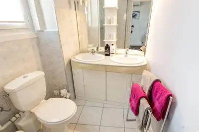 a white bathroom with a toilet and a sink at Lovely one bedroom apartment Gambetta Cannes in Cannes