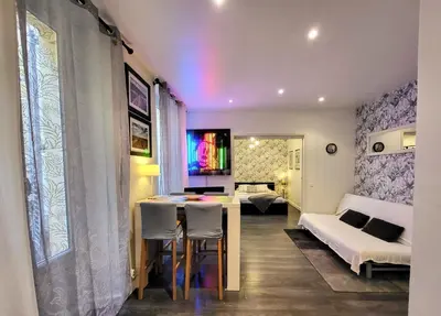 a room with a table and chairs and a bedroom at Cannes apartment - city center, AC / wifi in Cannes