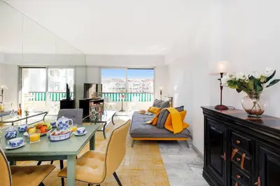 a living room with a table and a couch at Elegance in Le Cannet