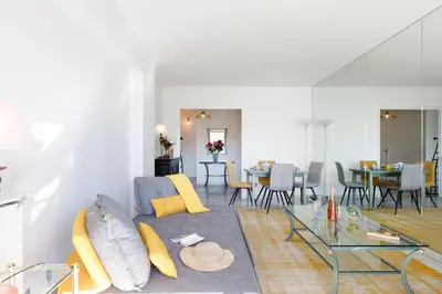 a living room with a couch and a glass table at Elegance in Le Cannet