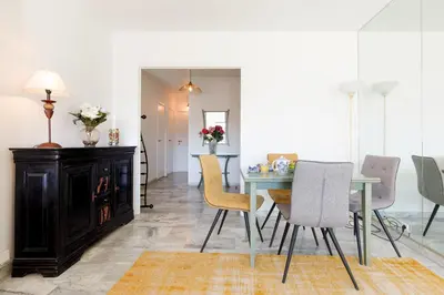 a dining room with a table and chairs at Elegance in Le Cannet