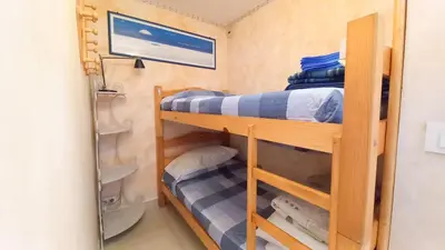 a bunk room with two bunk beds and a mirror at Les terrasses in Cannes