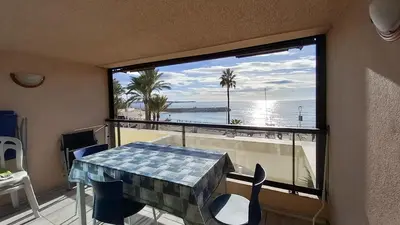 a room with a table and a window with a view of the ocean at Les terrasses in Cannes