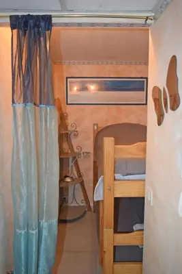 a small bedroom with a bunk bed in a tiny house at Les terrasses in Cannes
