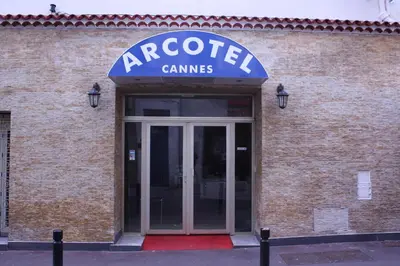 a brick building with a sign that reads arcoet games at Arcotel** Cannes in Cannes