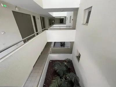 an overhead view of a hallway in a building with plants at Studio Piscine & Parking by Connexion in Cannes