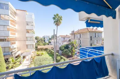 a balcony with a view of a pool and buildings at 2Br Apartment 100m from Beaches Terrace & Parking in Cannes