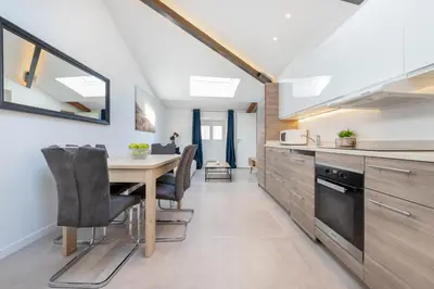 a kitchen with a table and chairs in a room at Residence Meynadier - apartments - New - AC - Wifi - Close Beach and Palais - LRA Cannes in Cannes