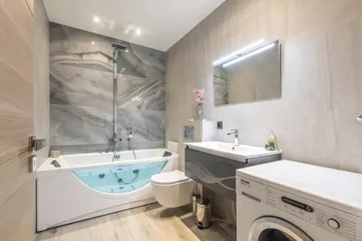 a bathroom with a tub and a toilet and a sink at Residence Meynadier - apartments - New - AC - Wifi - Close Beach and Palais - LRA Cannes in Cannes