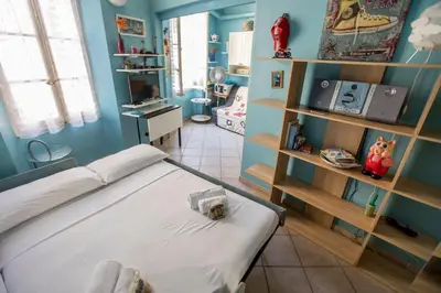 a bedroom with a bed in a room with blue walls at Le Suquet Style III by Connexion in Cannes