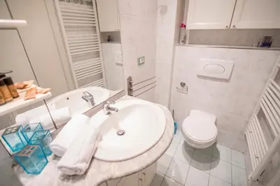 a white bathroom with a sink and a toilet at Le Suquet Style III by Connexion in Cannes