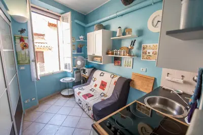 a small kitchen with a couch and a sink at Le Suquet Style III by Connexion in Cannes