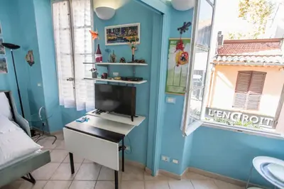 a bedroom with a tv and a desk in a room at Le Suquet Style III by Connexion in Cannes