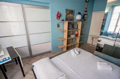 a room with a bed and a table and a shelf at Le Suquet Style III by Connexion in Cannes