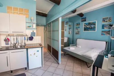 a room with a bed in the corner of a kitchen at Le Suquet Style III by Connexion in Cannes