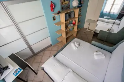 a small room with a white bed and a chair at Le Suquet Style III by Connexion in Cannes