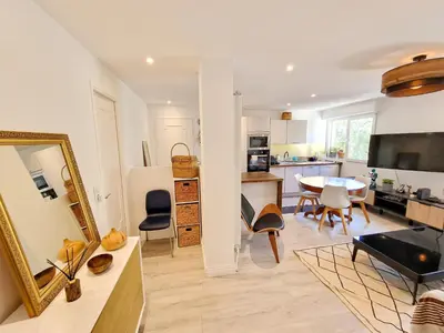 a kitchen and living room with a table and chairs at Cannes Appartement Palais Festivals in Cannes