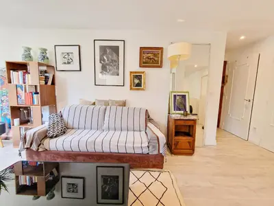 a bedroom with a bed and pictures on the wall at Cannes Appartement Palais Festivals in Cannes
