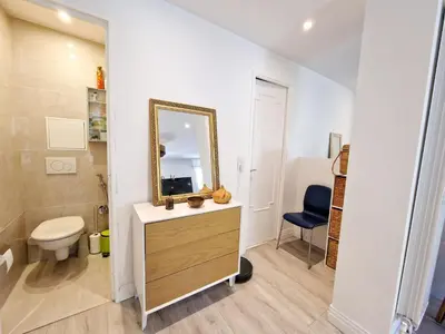 a bathroom with a sink and a mirror and a toilet at Cannes Appartement Palais Festivals in Cannes