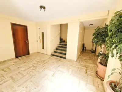 an empty hallway with stairs and potted plants at Cannes Appartement Palais Festivals in Cannes