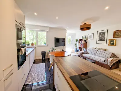 a kitchen and living room with a couch and a table at Cannes Appartement Palais Festivals in Cannes