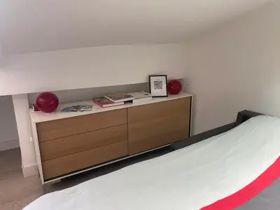 a bedroom with a bed with a wooden dresser at Studio cosy à côté du Palais des festivals in Cannes