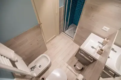a small bathroom with a toilet and a sink at La Casa Blu by Connexion in Cannes