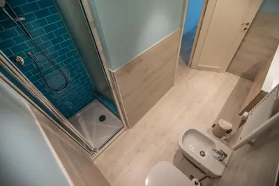 a small bathroom with a toilet and a shower at La Casa Blu by Connexion in Cannes