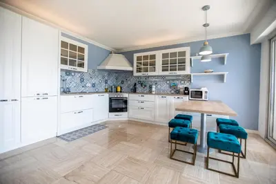 a kitchen with blue walls and a wooden table and chairs at La Casa Blu by Connexion in Cannes