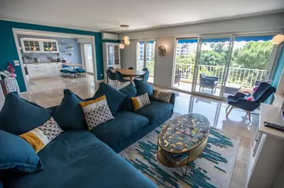 a living room with a blue couch and a table at La Casa Blu by Connexion in Cannes