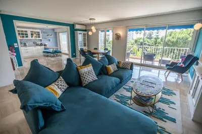 a living room with a blue couch and a table at La Casa Blu by Connexion in Cannes