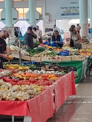 a market with tables full of fruits and vegetables at FORVILLE APARTMENT Cannes in Cannes