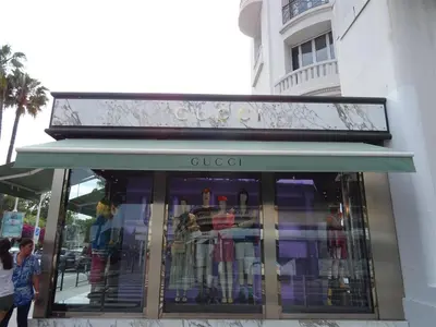 a store with a green awning on a building at Apartment Rue St Antoine in Cannes