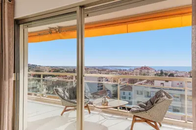 a view from the balcony of a apartment with a table and chairs at Superbe appartement à Cannes vue mer panoramique 