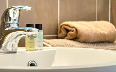 a bathroom sink with a faucet and a towel at Le Capri - Studio Wifi Californie in Cannes