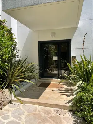 a door to a house with plants in front of it at Le Capri - Studio Wifi Californie in Cannes