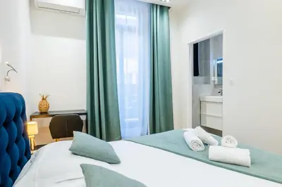 a hotel room with a bed and a window at 3-Br Apartment in the heart of downtown in Cannes