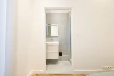 a bathroom with a sink and a mirror at 3-Br Apartment in the heart of downtown in Cannes
